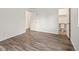 Bright bedroom featuring modern wood-look flooring and access to an ensuite bathroom at 298 S Hoover Ave, Louisville, CO 80027