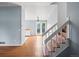 Bright entryway featuring wood floors, staircase, and an open layout connecting to other living spaces in the home at 298 S Hoover Ave, Louisville, CO 80027