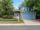 Inviting two-story home with brick accents, a well-manicured lawn, and a charming front entrance at 298 S Hoover Ave, Louisville, CO 80027