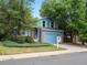 Charming blue two-story home with brick accents, manicured landscaping, and an attached garage at 298 S Hoover Ave, Louisville, CO 80027