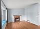 Cozy living room with a brick fireplace, wood floors, and a window seat offering natural light and comfort at 298 S Hoover Ave, Louisville, CO 80027