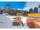 Large backyard with patio and snow at 7338 S Yukon Ct, Littleton, CO 80128