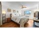 Bright bedroom with hardwood floors, a ceiling fan, large windows, and charming decor at 1175 N Emerson St # 308, Denver, CO 80218