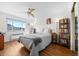 Comfortable bedroom featuring hardwood floors, a ceiling fan, and ample natural light from the window at 1175 N Emerson St # 308, Denver, CO 80218