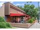 Trendy Dazbog Coffee shop exterior showcasing a vibrant mural and outdoor seating area at 1175 N Emerson St # 308, Denver, CO 80218