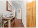 Inviting hallway featuring hardwood floors, decorative table, and a view leading to other rooms at 1175 N Emerson St # 308, Denver, CO 80218
