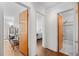 Hallway featuring doors to the bathroom, bedroom, and other rooms with hardwood floors at 1175 N Emerson St # 308, Denver, CO 80218