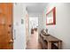 This hallway has wood-look floors and light-colored walls with a console table at 1175 N Emerson St # 308, Denver, CO 80218