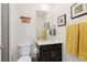 Cozy half bathroom with modern vanity and a framed mirror at 14278 Forest St, Thornton, CO 80602