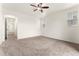 Spacious Primary bedroom with carpeting and view of the hallway, ceiling fan, and two windows at 14278 Forest St, Thornton, CO 80602