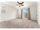 Bright Primary bedroom with sliding glass doors out to the deck and plush carpeting at 14278 Forest St, Thornton, CO 80602