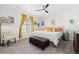 Bright bedroom with a ceiling fan, a large bed, and a storage ottoman at 14278 Forest St, Thornton, CO 80602