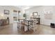 Bright dining area with natural light, hardwood floors, and stylish farmhouse table with chairs and bench at 14278 Forest St, Thornton, CO 80602