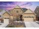 Beautiful two-story home with a well-manicured front yard and a three-car garage at 14278 Forest St, Thornton, CO 80602