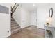 Bright foyer with hardwood floors, staircase, and white trim providing a welcoming entrance at 14278 Forest St, Thornton, CO 80602