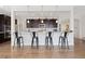 Breakfast bar with seating in an open kitchen with dark wood cabinets and stainless steel appliances at 14278 Forest St, Thornton, CO 80602