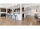 Open concept kitchen featuring a breakfast bar, dark wood cabinets, and stainless steel appliances at 14278 Forest St, Thornton, CO 80602