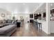 Open-concept living area features hardwood floors connecting the kitchen, dining area, and living room at 14278 Forest St, Thornton, CO 80602