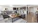 Open-concept living room featuring hardwood floors and an eat-in kitchen with barstool seating at 14278 Forest St, Thornton, CO 80602