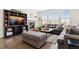 Living room boasts a fireplace with stone surround, built-in shelves and a large picture window at 14278 Forest St, Thornton, CO 80602