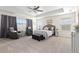 Spacious primary bedroom with tray ceiling, sitting area, and ample natural light at 14278 Forest St, Thornton, CO 80602