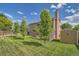 Spacious backyard featuring a lush lawn, mature trees, and a storage shed for added convenience at 4203 E 126Th Ave, Thornton, CO 80241