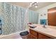 Bathroom with a single sink, a shower and tub combo, and light blue walls at 4203 E 126Th Ave, Thornton, CO 80241
