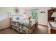 Bedroom with a metal bed frame and patterned bedding complemented by natural light from a window at 4203 E 126Th Ave, Thornton, CO 80241