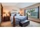 Cozy bedroom featuring a decorative headboard and a window at 4203 E 126Th Ave, Thornton, CO 80241
