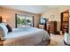 Bedroom featuring a comfortable bed, dresser, TV, and an adjacent bathroom for added convenience at 4203 E 126Th Ave, Thornton, CO 80241
