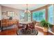 Charming dining room featuring a round table, wood floors, and plenty of natural light from the windows at 4203 E 126Th Ave, Thornton, CO 80241
