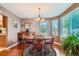 Bright dining area with hardwood floors, large windows, and a classic wooden table at 4203 E 126Th Ave, Thornton, CO 80241