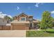 Beautiful two-story home with a well-maintained lawn, mature tree, and an attached two-car garage at 4203 E 126Th Ave, Thornton, CO 80241
