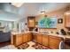 Bright kitchen featuring oak cabinetry, white countertops, and a stainless steel dishwasher at 4203 E 126Th Ave, Thornton, CO 80241