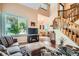 Bright living room with large windows, a staircase, hardwood floors, and comfortable seating at 4203 E 126Th Ave, Thornton, CO 80241