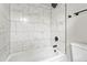 Bathroom with a modern bathtub, sleek white tile, and contemporary black hardware at 6800 E Tennessee Ave # 541, Denver, CO 80224