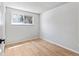 Cozy bedroom featuring laminate flooring, a window letting in natural light, and neutral-colored walls at 6800 E Tennessee Ave # 541, Denver, CO 80224