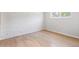 Cozy bedroom featuring wood-look floors and a painted brick wall at 6800 E Tennessee Ave # 541, Denver, CO 80224