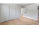 Bedroom with light, neutral walls, wood-look flooring, and a closet at 6800 E Tennessee Ave # 541, Denver, CO 80224