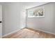 Bright bedroom features wood-look floors, closet, and window with view at 6800 E Tennessee Ave # 541, Denver, CO 80224