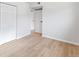 Light and bright bedroom with wood-look flooring and neutral walls at 6800 E Tennessee Ave # 541, Denver, CO 80224