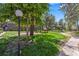 Complex courtyard with well-manicured lawn, mature trees, and walkways at 6800 E Tennessee Ave # 541, Denver, CO 80224