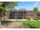Apartment complex with red brick exterior, balconies, and landscaping at 6800 E Tennessee Ave # 541, Denver, CO 80224