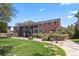 Brick apartment complex with well-maintained landscaping and outdoor lighting at 6800 E Tennessee Ave # 541, Denver, CO 80224