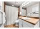Cozy bathroom with tile flooring, shower with curtain, and vanity at 11771 Elk Head Range Rd, Littleton, CO 80127
