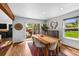 Dining room with wood floors, bright natural light, and sliding door access to the patio at 11771 Elk Head Range Rd, Littleton, CO 80127