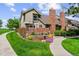 Charming two-story home featuring a brick facade and well-maintained landscaping with lush green lawn at 11771 Elk Head Range Rd, Littleton, CO 80127