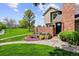 Charming two-story home with beautiful landscaping, colorful flowers, and lush green lawn at 11771 Elk Head Range Rd, Littleton, CO 80127