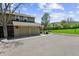 Home featuring an attached two-car garage with lush green lawns and mature trees in the neighborhood at 11771 Elk Head Range Rd, Littleton, CO 80127