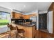 Updated kitchen features stainless steel appliances, wood cabinets, and a sleek black countertop with seating at 11771 Elk Head Range Rd, Littleton, CO 80127